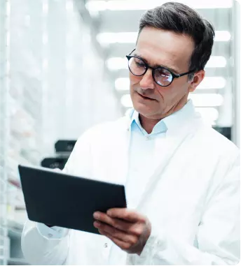 Healthcare provider looking at a tablet to acquire product through a specialty pharmacy (SP)